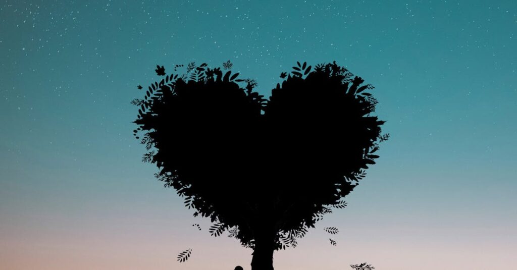 Silhouette of a person under a heart-shaped tree against a twilight sky.